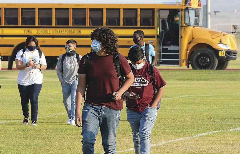 FILE â€” In this Sept. 17, 2020, file photo, students in face masks arrive on the Gila Ridge High School campus on the second first day of school, in Yuma, Ariz. School officials say several men threatened to make a citizenâ€™s arrest of an Arizona school principal while at least one brandished cable ties in a confrontation over virus rules. Mesquite Elementary School’s principal called police Thursday, Sept. 2, 2021, after she met with the men and they initially refused to leave. The arrest is the latest in a number of confrontations and other encounters in school settings over virus-related rules. (Randy Hoeft/The Yuma Sun via AP, File ) AZYUM501 AZYUM501