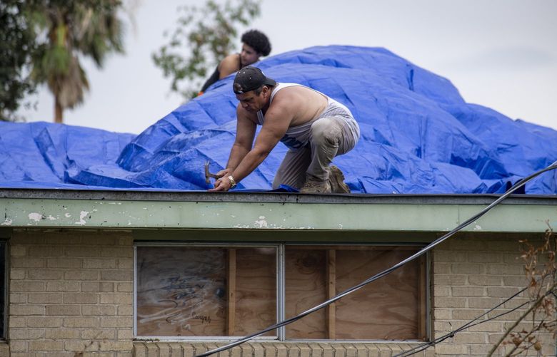 A roof is covered with tarps on Monday, Sept. 6, 2021, in Kenner, La., a week after Hurricane Ida swept through the area. (Chris Granger/The Times-Picayune/The New Orleans Advocate via AP) LAORS503 LAORS503