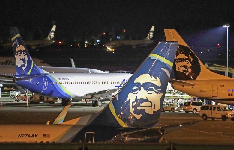 FILE – In this Friday, Aug. 10, 2018, file photo, Alaska Airlines planes sit on the tarmac at Sea-Tac International Airport in SeaTac, Wash. Officials say an Alaska Airlines jetliner struck a brown bear while landing early Saturday evening, Nov. 14, 2020, killing the animal and causing damage to the plane. (AP Photo/Elaine Thompson, File) NYSB737