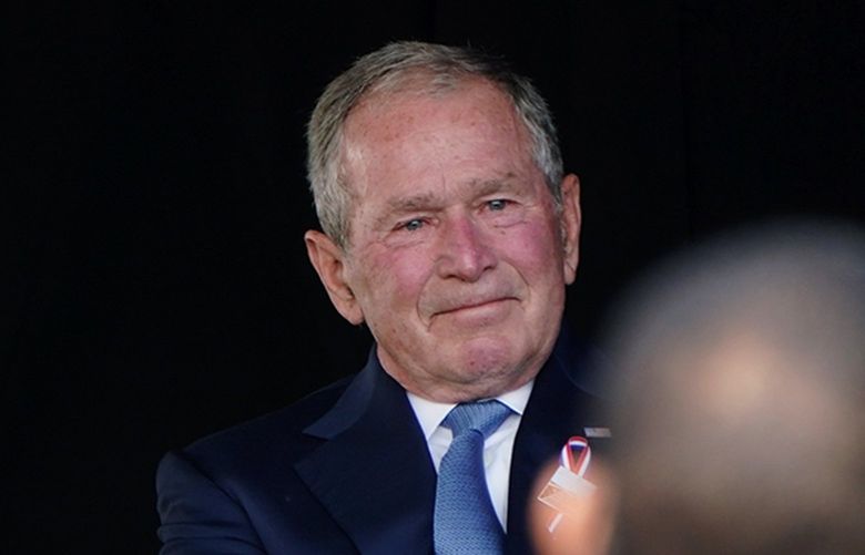 Former President George W. Bush, right, next to former first lady Laura Bush, takes his seat after he spoke at a memorial for the passengers and crew of United Flight 93, Saturday, Sept. 11, 2021, in Shanksville, Pa., on the 20th anniversary of the Sept. 11, 2001, attacks. (AP Photo/Jacquelyn Martin) PAJM224 PAJM224