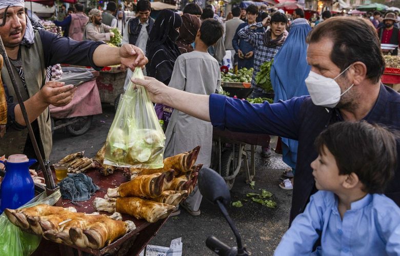 A vendor sells beef feet at the Mandai market in Kabul, Afghanistan on Monday, Sept. 13, 2021. The plight of the Afghan people came into stark relief on Monday when top United Nations officials warned that millions of people could run out of food before the arrival of winter and one million children could die if their immediate needs are not met. (Victor J. Blue/The New York Times) XNYT35