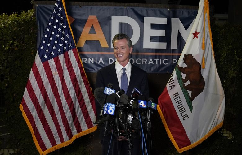 California Gov. Gavin Newsom addresses reporters after beating back the recall attempt that aimed to remove him from office at the John L. Burton California Democratic Party headquarters in Sacramento, Calif., Tuesday, Sept. 14, 2021. (AP Photo/Rich Pedroncelli) CARP219 CARP219