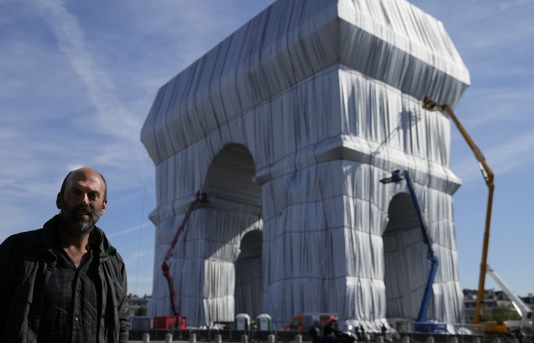 Vladimir Yavachev, a nephew of late artist Christo, who leads the “L’Arc de Triomphe, Wrapped” project poses near the Arc de Triomphe monument, in Paris, on Thursday. The “L’Arc de Triomphe, Wrapped” project  will be on view from Saturday through Oct. 3. (AP Photo/Francois Mori) 