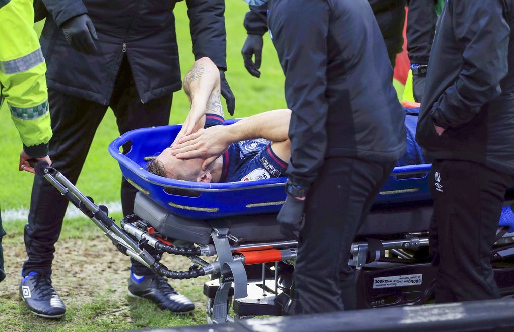 Swansea City’s Jordan Morris is stretchered off the field after getting injured during a Sky Bet Championship soccer match against Huddersfield, Feb. 20, 2021, at John Smith’s Stadium in Huddersfield, England. (Mike Egerton / PA via AP)