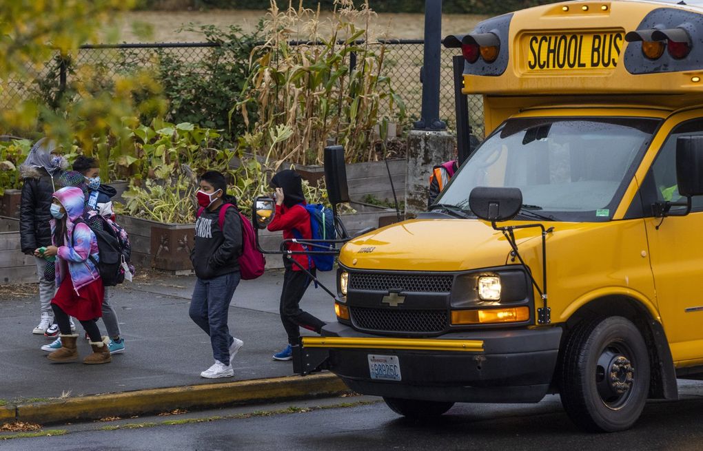 Students pass a school bus after being dropped off at Rising Star Elementary School on Friday, Sept. 17, 2021. 218246