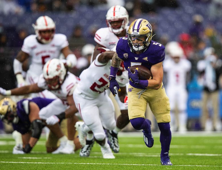 Sean McGrew is off and running, scoring from the 13 in the first quarter, Sept. 18, 2021 against Arkansas State in Seattle. (Dean Rutz / The Seattle Times)