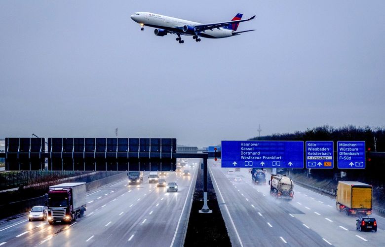 An aircraft of Delta Airline flies over the highway as it approaches the airport in Frankfurt, Germany, Wednesday, Feb. 3, 2021. To avoid the outspread of the Coronavirus Germany has imposed carious travel restrictions. (AP Photo/Michael Probst) PFRA105