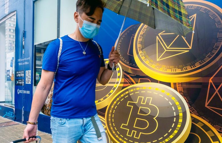 A pedestrian walks past signage for Ethereum, top, and Bitcoin outside the Hong Kong Digital Asset Exchange Ltd. digital currency trading store in Hong Kong, China, on Thursday, June 24, 2021. Hong Kong Digital Asset Exchange is a cryptocurrency platform and is the first to combine online and physical exchange in Hong Kong. 775672103