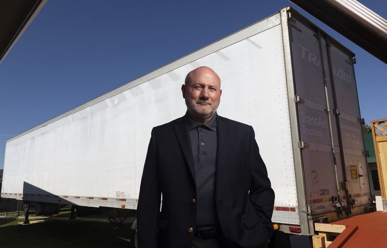 Dave Salove, managing partner at Cloverdale Funeral Home, stands outside a 53-foot refrigerated truck the funeral home has brought in to deal with a surge in bodies. MUST CREDIT: photo for The Washington Post by Kyle Green.