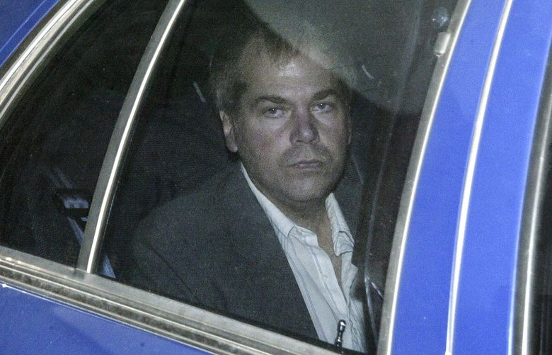 FILE – In this Nov. 18, 2003, file photo, John Hinckley Jr. arrives at U.S. District Court in Washington. Lawyers are scheduled to meet in federal court on Monday, Sept. 27, 2021 to discuss whether Hinckley Jr., the man who tried to assassinate President Ronald Reagan, should be freed from court-imposed restrictions including overseeing his medical care and keeping up with his computer passwords. (AP Photo/Evan Vucci, File) AX102 AX102