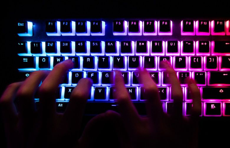 A person typing at a backlit computer keyboard in, Dec. 29, 2020. . MUST CREDIT: Bloomberg photo by Chris Ratcliffe