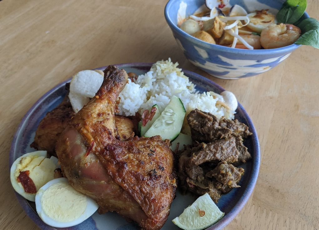 Kirkland’s Reunion specializes in Malaysian fare, like big bowls of seafood laksa and chili-rubbed roast chicken and lemon grass beef. (Jackie Varriano / The Seattle Times)
