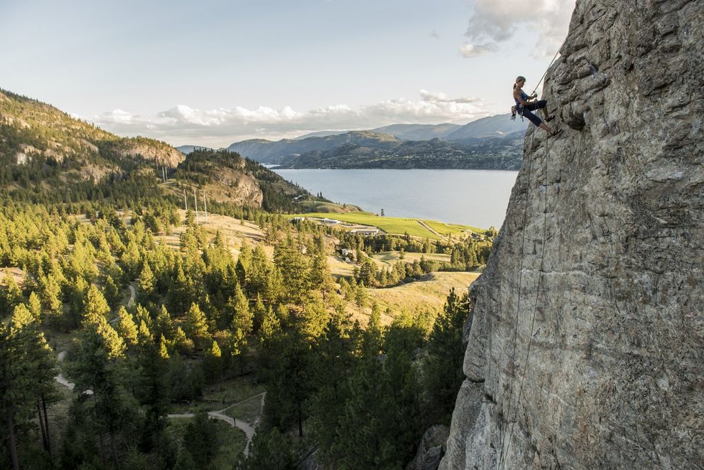 A climber rests while scaling a rock wall at Skaha Bluffs Provincial Park in British Columbia. (Kari Medig / Destination BC)