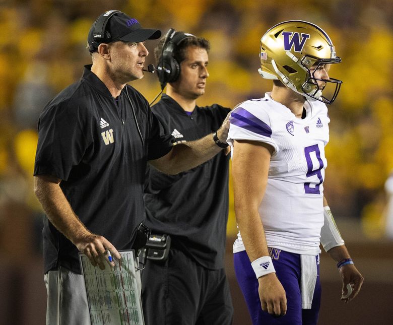 Washingotn offensive coordinator John Donovan sends quarterback Dylan Morris in with a play during the first quarter against Michigan, Sept. 11, 2021, in Ann Arbor, Mich. (Dean Rutz / The Seattle Times)