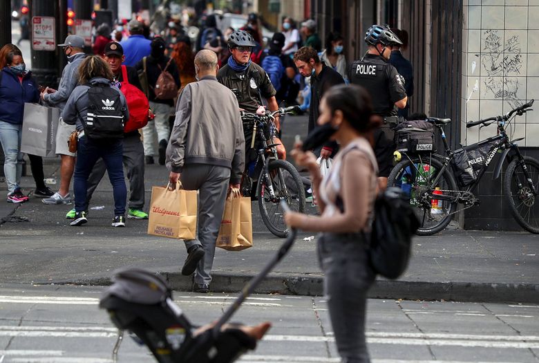 Police on bikes are seen on Third Avenue. Downtown residents say the landscape of addiction, homelessness and crime in their neighborhood has gotten worse in the last two years. (Ken Lambert / The Seattle Times)