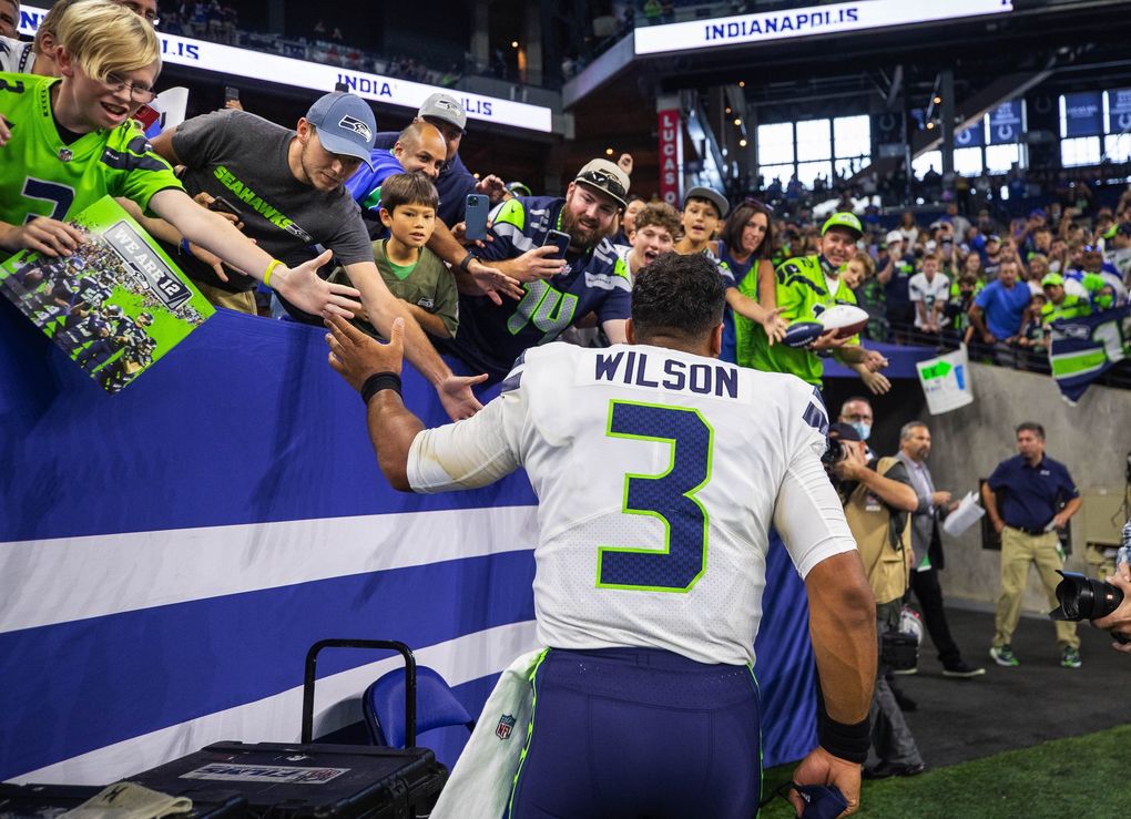 Russell Wilson celebrates with the 12s at Lucas Oil Stadium after Seattle’s 28-16 win over Indianapolis Sunday. (Dean Rutz / The Seattle Times)