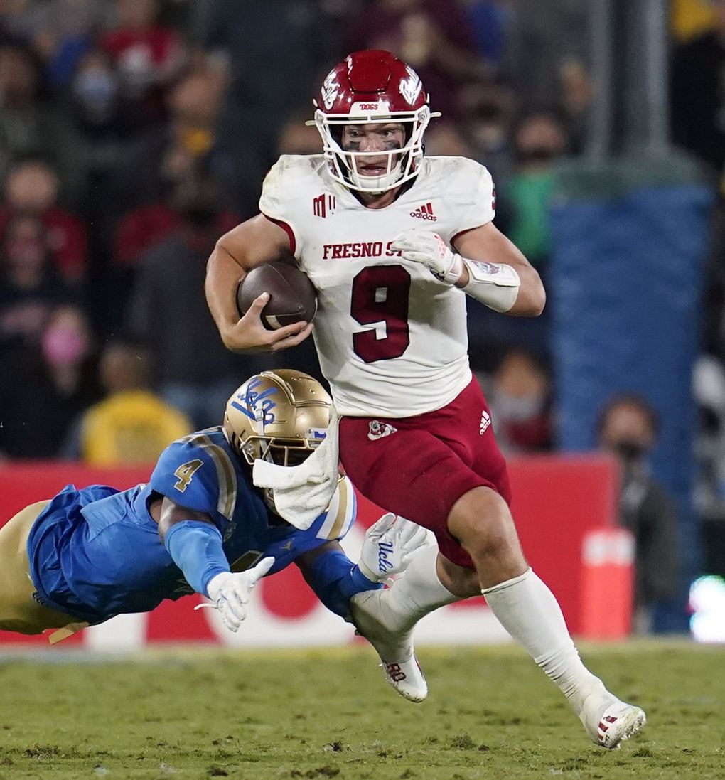 Fresno State quarterback Jake Haener (9) runs past UCLA defensive back Stephan Blaylock (4) during the second half of an NCAA college football game Sunday, Sept. 19, 2021, in Pasadena, Calif. (Marcio Jose Sanchez / The Associated Press)