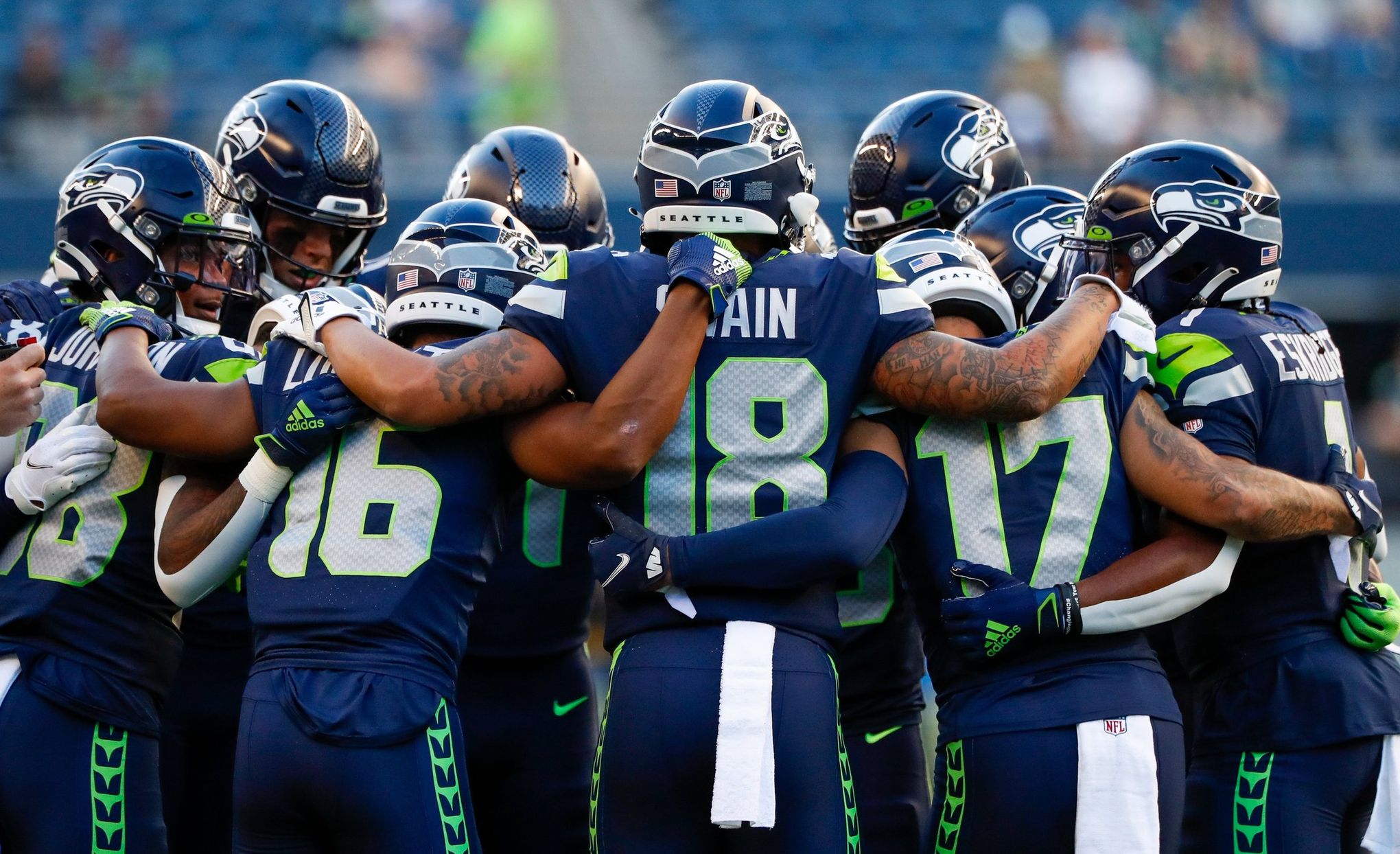 The Seattle Seahawks huddle during an NFL football game against