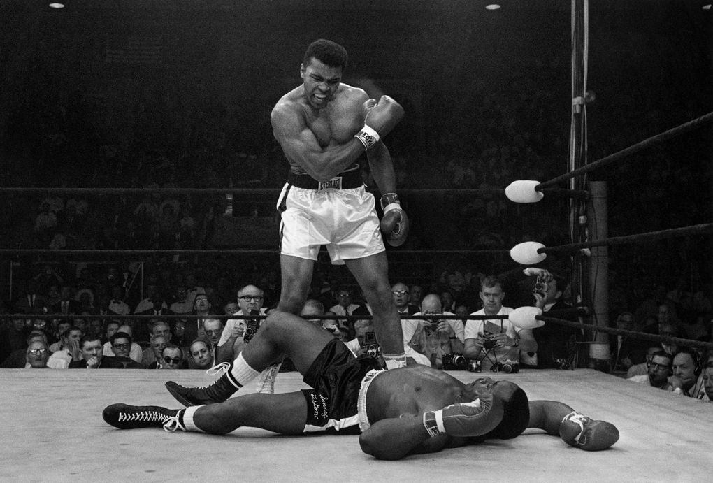Muhammad Ali stands over the fallen Sonny Liston shortly after dropping his opponent with a right to the jaw on May 25, 1965, in Lewiston, Maine. The moment is part of Ken Burns’ latest PBS opus, “Muhammad Ali,” running Sept. 19-22. (John Rooney / The Associated Press)
