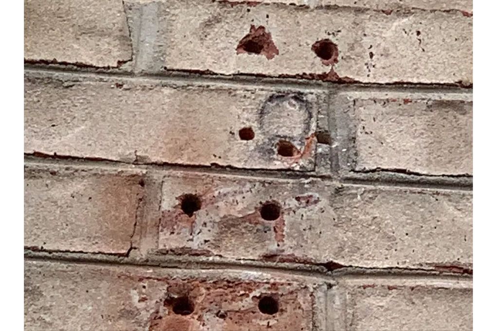 How can I fill the holes in the bricks on my house?