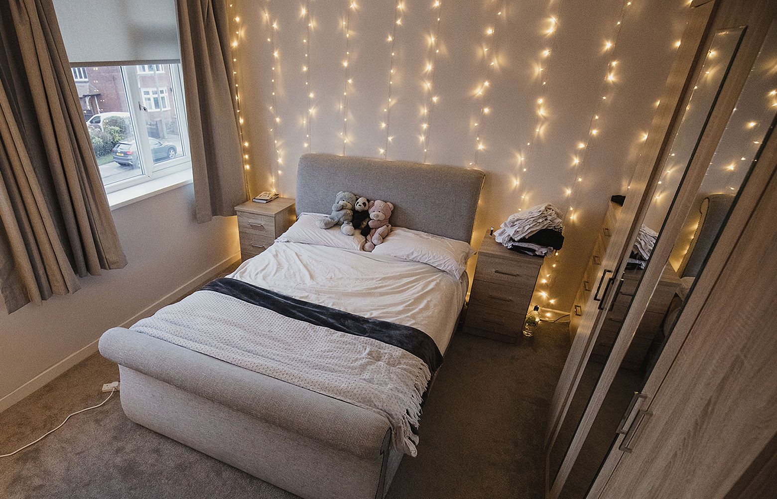 Fairy lights store behind bed