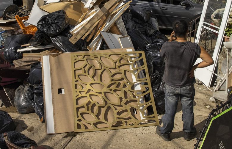 FILE — Debris removed from homes flooded by the remnants of Hurricane Ida in New York, Sept. 3, 2021. As extreme weather becomes more common, insurance companies are rethinking which homes to cover and at what price. (Benjamin Norman/The New York Times)