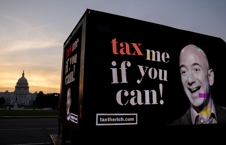 A sign featuring Jeff Bezos calls for taxing the rich in Washington on Sept. 15, 2021. MUST CREDIT: Bloomberg photo by Stefani Reynolds