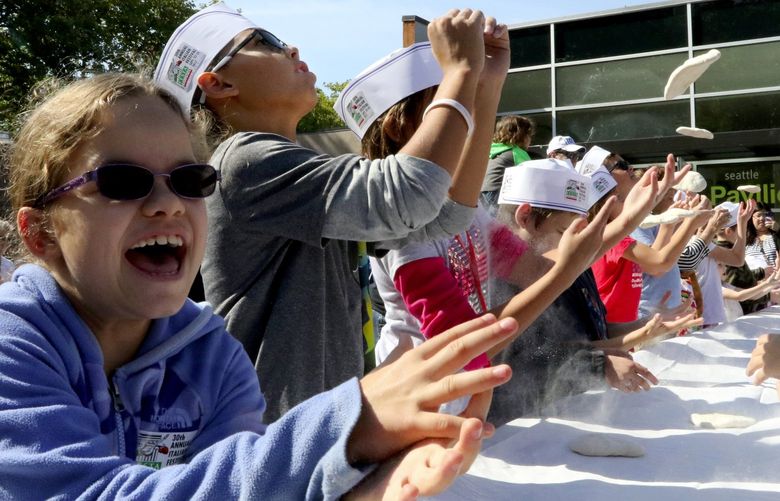 It great fun and laughs learning to toss pizza dough at the 30th annual Italian Festival at Seattle Center. The event is for children only and takes place again Sunday at noon, 2 and 4pm. Grape stomps, a Bocce tournament, cooking demonstrations, entertainment and much more continues from 10:30 a.m. with free admission.
more photos online
LO Linesonly from the 30th annual Italian Festival 2017.
Saturday, Sept. 23, 2017.