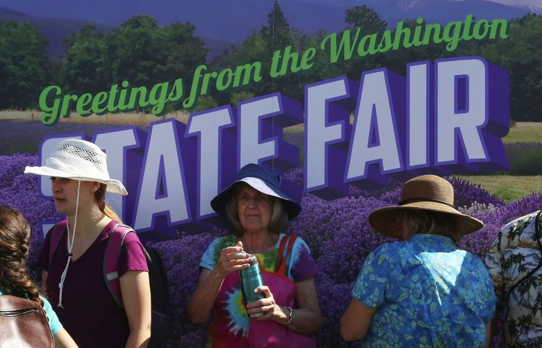 A giant postcard at the Washington State Fair provides some shade Friday and also provides a backdrop for a souvenir photo at the fairgrounds in Puyallup.

Friday Sept 11, 2015
