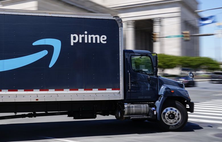 FILE – An Amazon truck drives in in Philadelphia, Friday, April 30, 2021. Amazon wants to hire 125,000 delivery and warehouse workers and said Tuesday, Sept. 14, 2021 that it is paying new hires an average of $18 an hour in a tight job market as more people shop online. The company is also offering pay sign-on bonuses of $3,000 in some parts of the country. (AP Photo/Matt Rourke, file) NYPS202 NYPS202