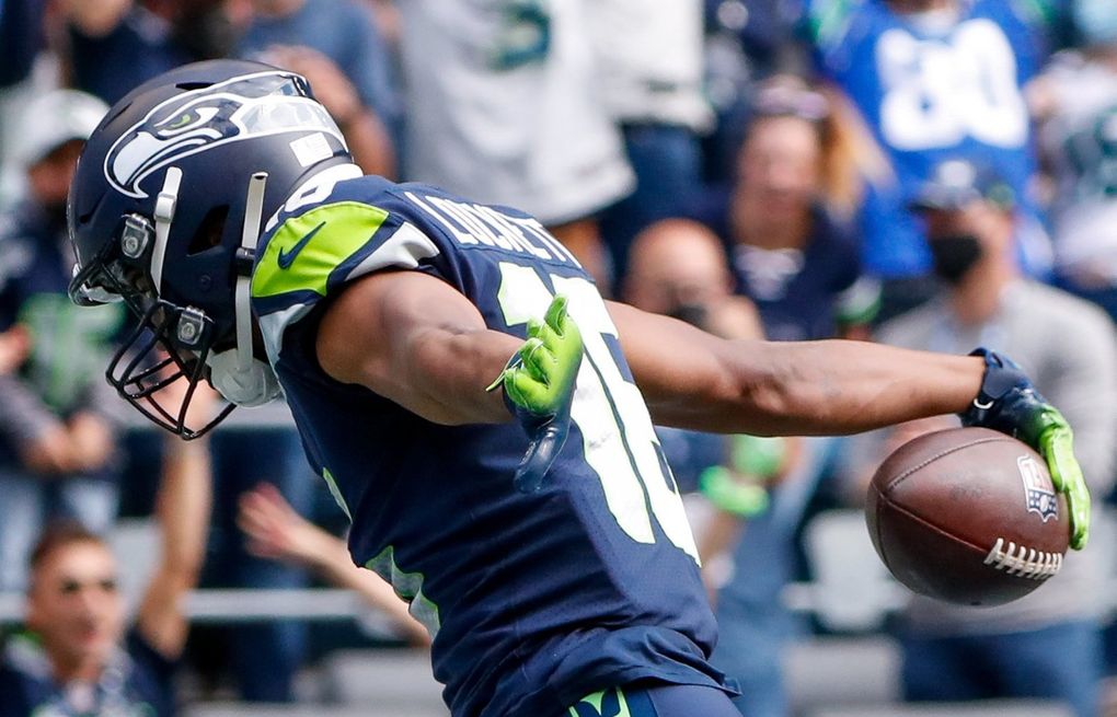 Wide receiver Tyler Lockett of the Seattle Seahawks smiles between