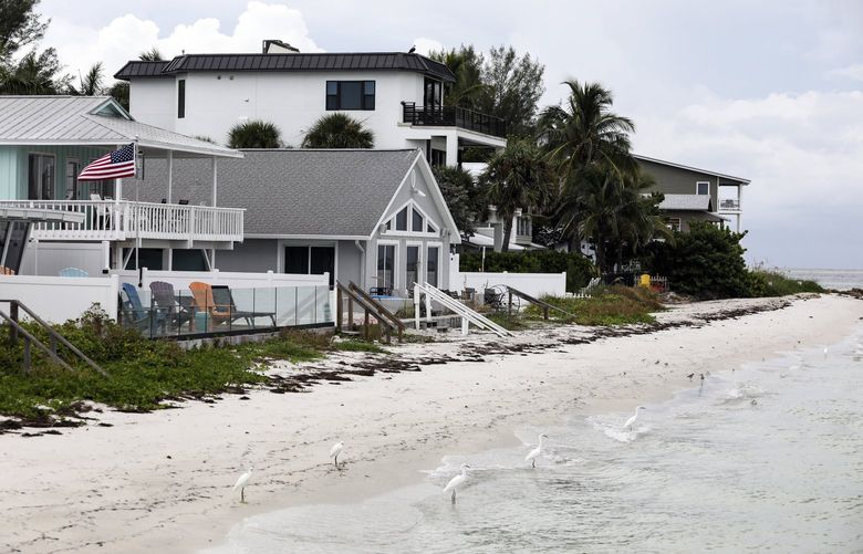 Beachfront homes in Anna Maria, Fla., on Sept. 20, 2021.  One ZIP code in the area leads the country in the number of single-family homes facing an increase of more than $1,200 for flood insurance. (Eve Edelheit/The New York Times) XNYT2