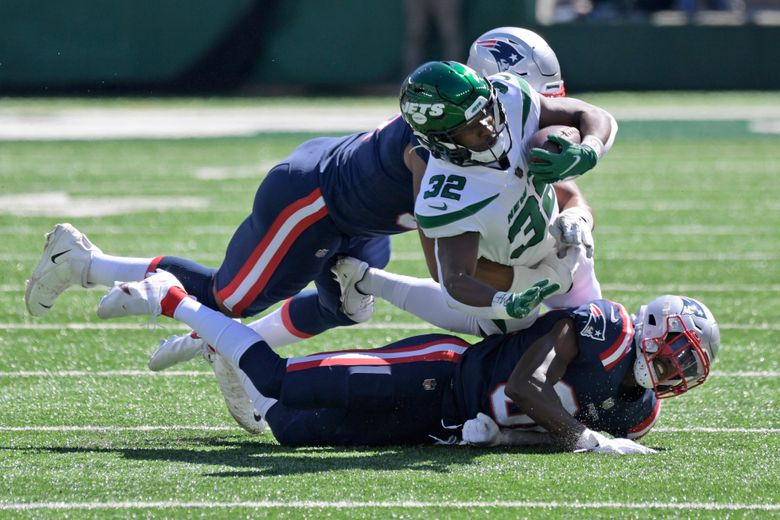 New York Jets running back Michael Carter (32) is tackled during