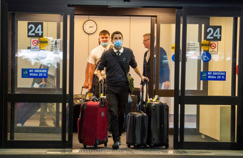 Missionaries visiting the Philippines return to the U.S. at Salt Lake International Airport in March 2020. Faith groups are taking various approaches to COVID-19 vaccines for missionaries. The Church of Jesus Christ of Latter-day Saints gives unvaccinated missionaries assignments in their home countries. The Southern Baptist Convention’s International Mission Board requires the COVID-19 vaccine. (Rick Egan/The Salt Lake Tribune via AP)