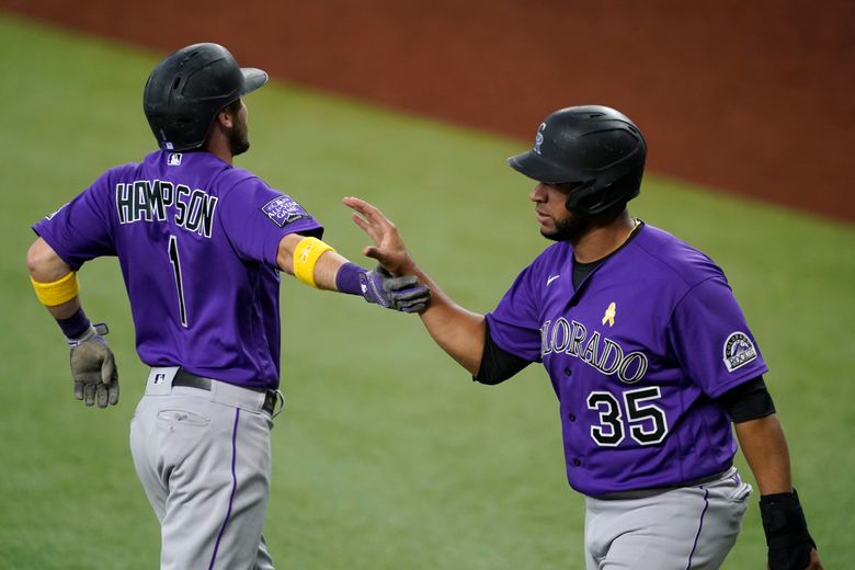 Elias Diaz of the Colorado Rockies celebrates with Brendan Rodgers