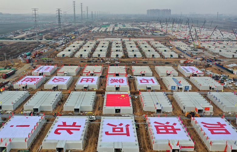 In this aerial photo released by China’s Xinhua News Agency, construction workers build a quarantine center which, according to state media, will have over 4,000 rooms to isolate close contacts of COVID-19 cases in Shijiazhuang in northern China’s Hebei Province, Wednesday, Jan. 20, 2021. China is imposing some of its toughest travel restrictions yet as coronavirus cases surge in several northern provinces ahead of the Lunar New Year. (Yang Shiyao/Xinhua via AP) XIN803