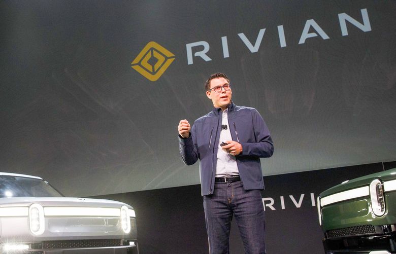 RJ Scaringe, founder and chief executive officer of Rivian Automotive Inc., unveils the R1T electric pickup truck, left, and R1S electric sports utility vehicle (SUV) during a reveal event at AutoMobility LA ahead of the Los Angeles Auto Show in Los Angeles, California, U.S., on Tuesday, Nov. 27, 2018. With its crew-cab and short bed, the R1T seems to be taking aim at the Ford F-150 Raptor. Photographer: Patrick T. Fallon/Bloomberg 775264210