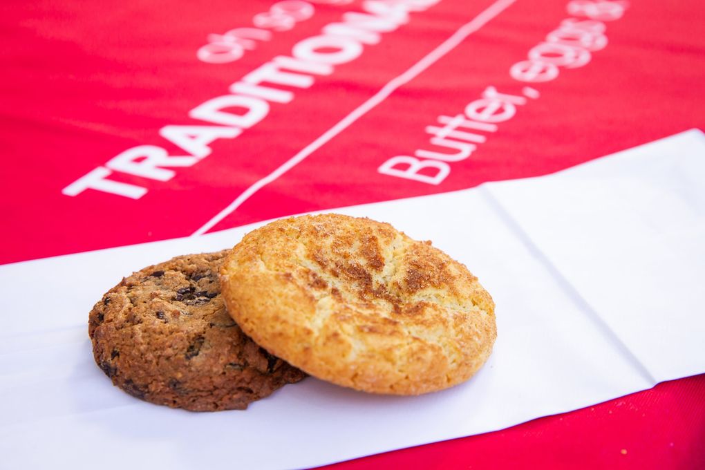 A classic soft snickerdoodle cookie, right, and the Bing Bling, featuring dried Bing cherries, dark Belgian chocolate chips and coconut, are two popular options for traditional cookies — made with butter, eggs and wheat — at Pinckney Cookie Cafe.(Bettina Hansen / The Seattle Times)