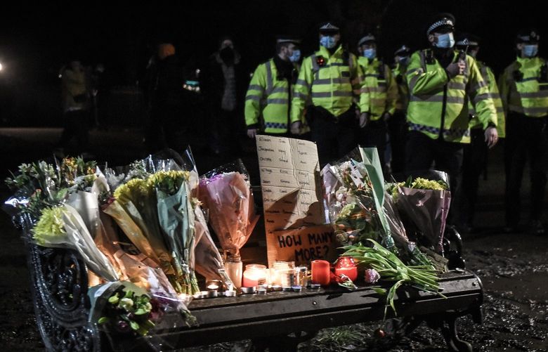 FILE â€” Police officers walk past a makeshift memorial for Sarah Everard after they attempted to disperse a vigil in Clapham Common, London, March 13, 2021. Faced with nationwide consternation over a police officerâ€™s rape and murder of Everard, the London police have offered several safety tips to women in the event they come face-to-face with an officer they consider a threat, or someone posing as one. The advice provoked widespread criticism and mockery. (Mary Turner/The New York Times) XNYT71 XNYT71