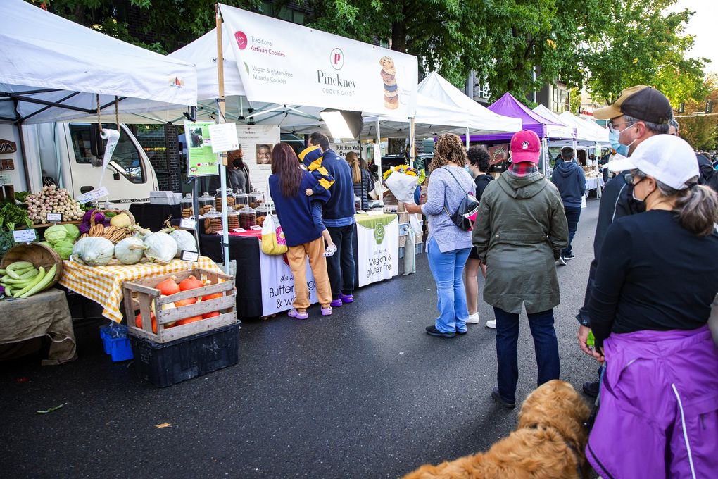 Customers line up at the Pinckney Cookie Cafe booth at the University District Farmers Market in Seattle Saturday, Sept. 18, 2021. (Bettina Hansen / The Seattle Times)