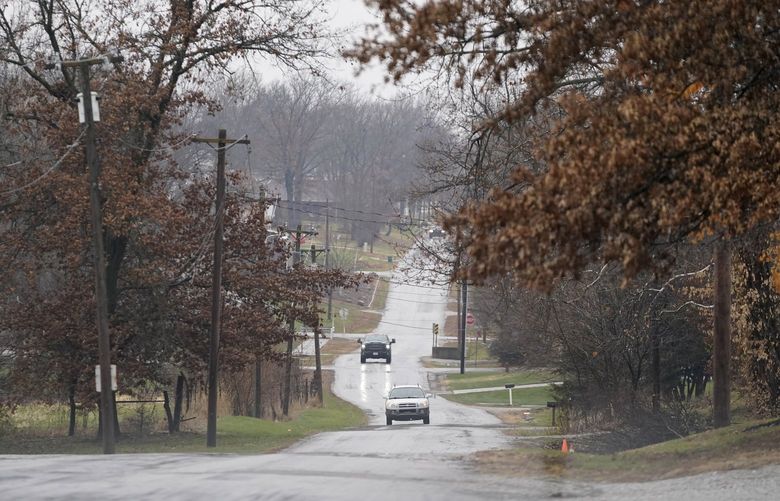 Cars drive on a road near Scotland County Hospital Tuesday, Nov. 24, 2020, in Memphis, Mo. The tiny hospital in rural northeast Missouri is seeing an alarming increase in coronavirus cases. (AP Photo/Jeff Roberson)