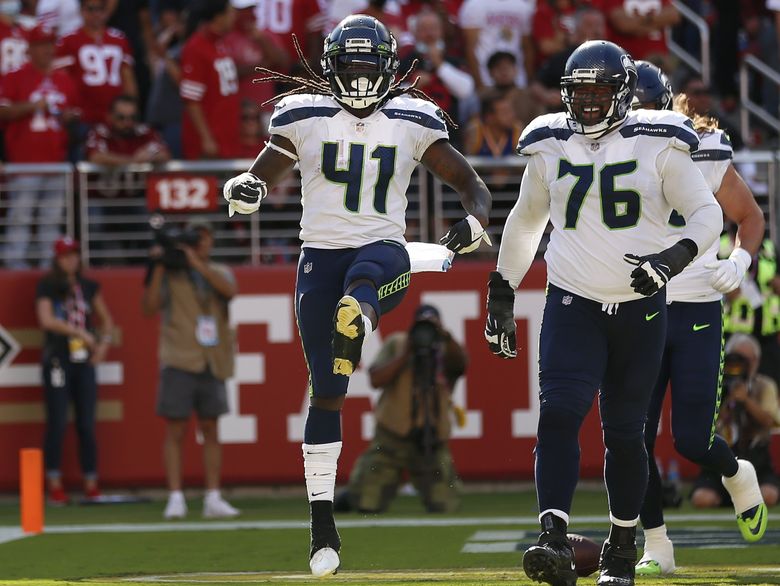 Seattle Seahawks running back Alex Collins carries the ball against the  Denver Broncos during the first half of an NFL football preseason game,  Saturday, Aug. 21, 2021, in Seattle. (AP Photo/John Froschauer