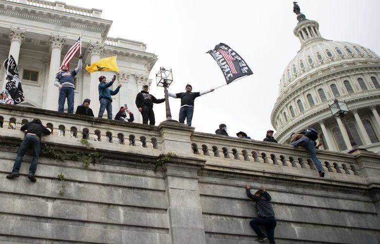 Supporters of President Donald Trump climb the west wall of the the U.S. Capitol on Wednesday, Jan. 6, 2021, in Washington. (AP Photo/Jose Luis Magana) DCJL132