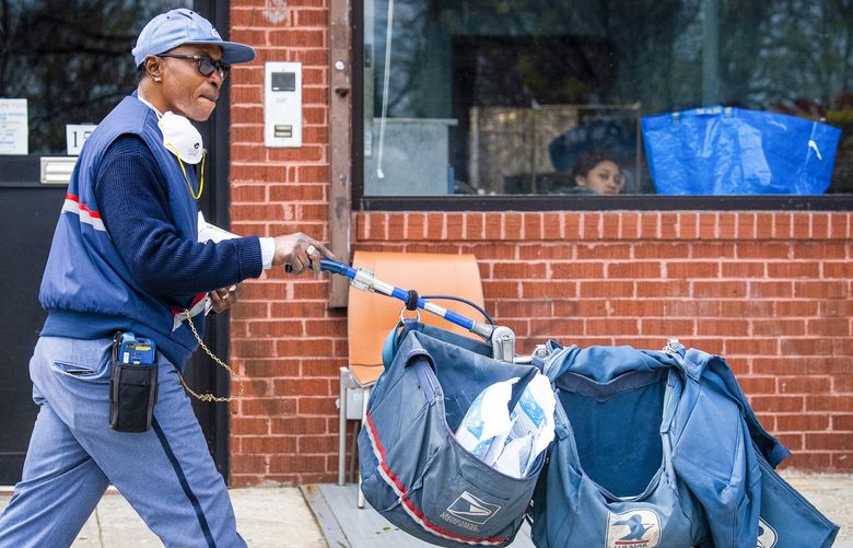 FILE — A postal worker on a delivery route in Brooklyn’s Windsor Terrace neighborhood on April 14, 2020. The path to student loan forgiveness has just gotten easier for many government workers, nonprofit employees and others who work for the public good. (Joshua Bright/The New York Times) XNYT38