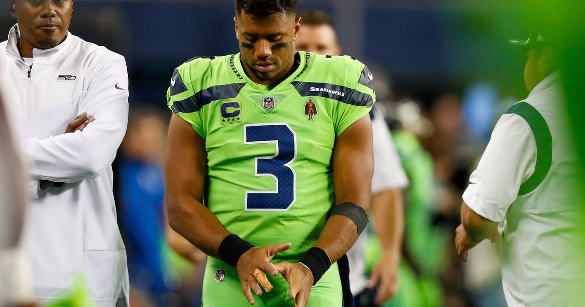 FILE - In this Nov. 11, 2018, file photo, Seattle Seahawks quarterback  Russell Wilson (3) battles Los Angeles Rams defensive end Aaron Donald (93)  for a ball Wilson lost on a fumble