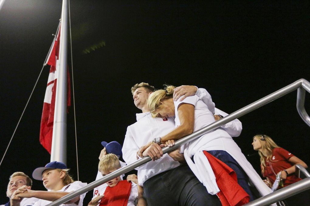 Ryan comforting his mother, Kym, at a Washington State game in September 2018, after Tyler’s death. (Young Kwak / AP)