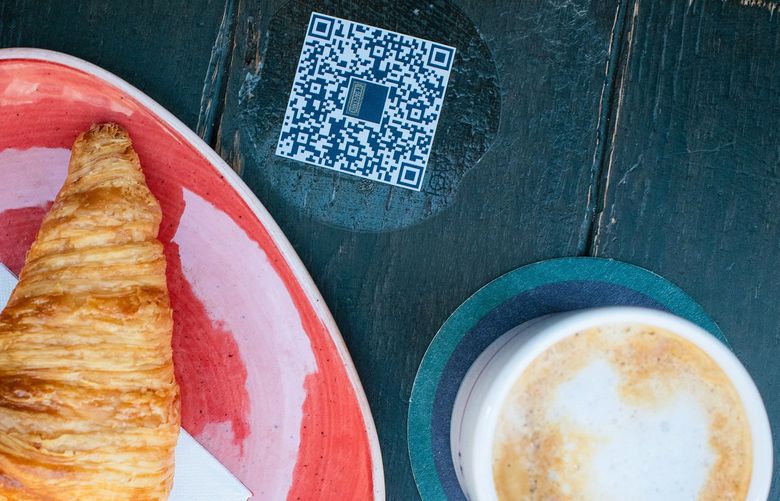 A menu in the form of a QR code at a cafe in Paris on Sept. 11, 2021. For some customers, it’s a nice feature but for others uncomfortable with new technology, it’s a customer inconvenience. (Dmitry Kostyukov/The New York Times) XNYT97