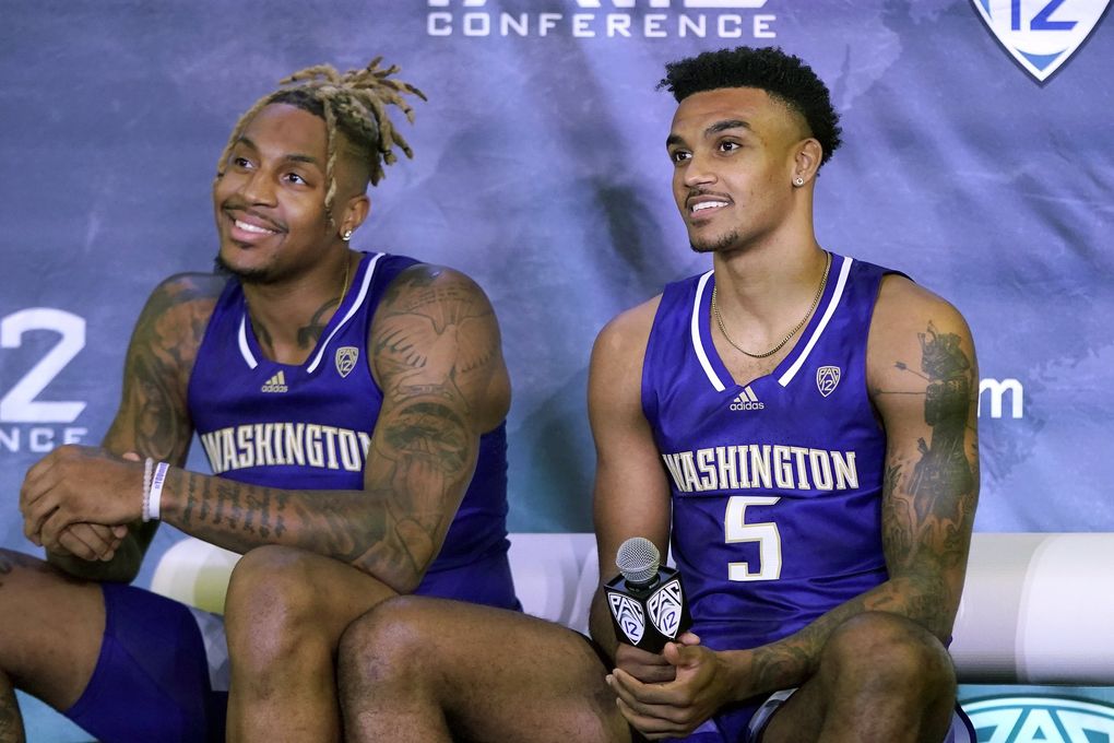 Washington’s Nate Roberts, left, and Jamal Bey listen to questions during Pac-12 Conference basketball media day Wednesday, Oct. 13, 2021, in San Francisco. (Jeff Chiu / AP)