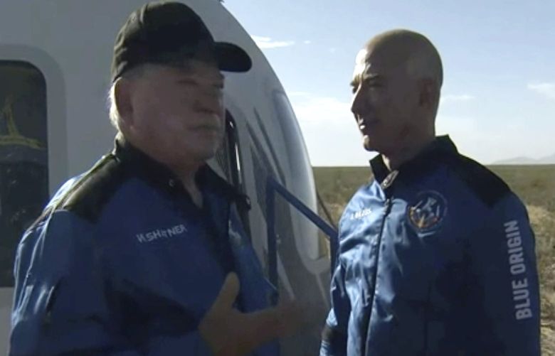 In this image provided by Blue Origin, William Shatner talks with Jeff Bezos about his experience after exiting the Blue Origin capsule near Van Horn, Texas, Wednesday, Oct. 13, 2021.  The â€œStar Trekâ€ actor and three fellow passengers hurtled to an altitude of 66.5 miles (107 kilometers) over the West Texas desert in the fully automated capsule, then safely parachuted back to Earth in a flight that lasted just over 10 minutes.  (Blue Origin via AP) TXHO102 TXHO102