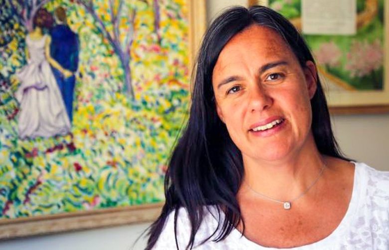 Jennifer Stuber, with a painting gifted at her wedding, and she and her husband Matt’s wedding Ketubah.